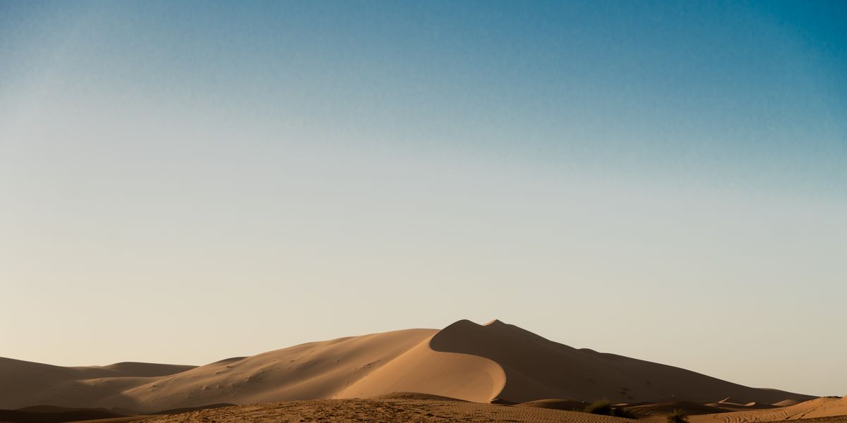 Sand dunes under a pale sky