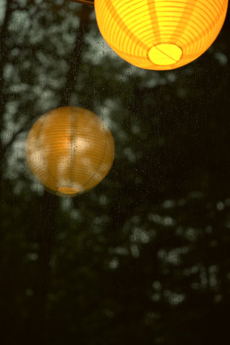 A warm lantern reflected in glass